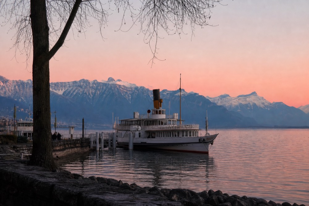 The Montreux waterfront on Lake Geneva with a CGN boat at the quay, the Alps across the water