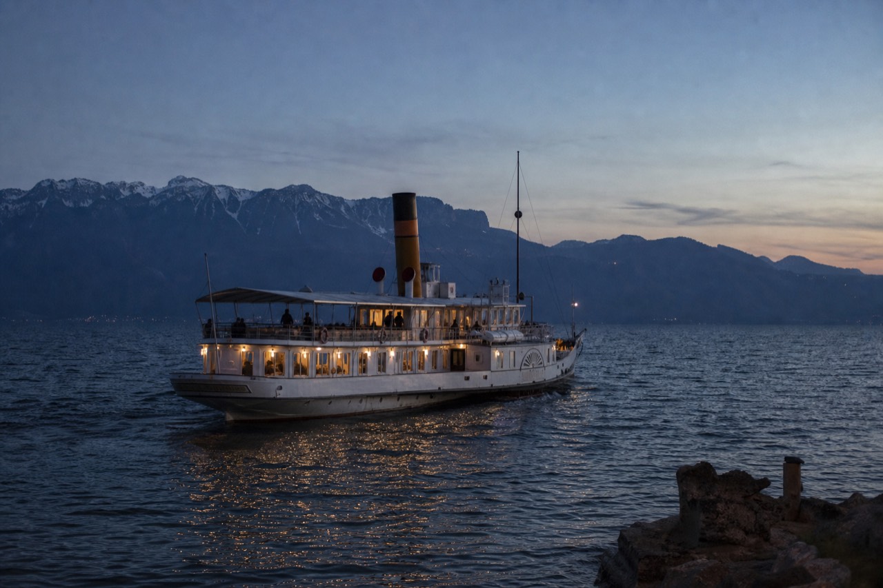 A CGN scheduled cruise boat on Lake Geneva off Lausanne-Ouchy, the Alps across the water