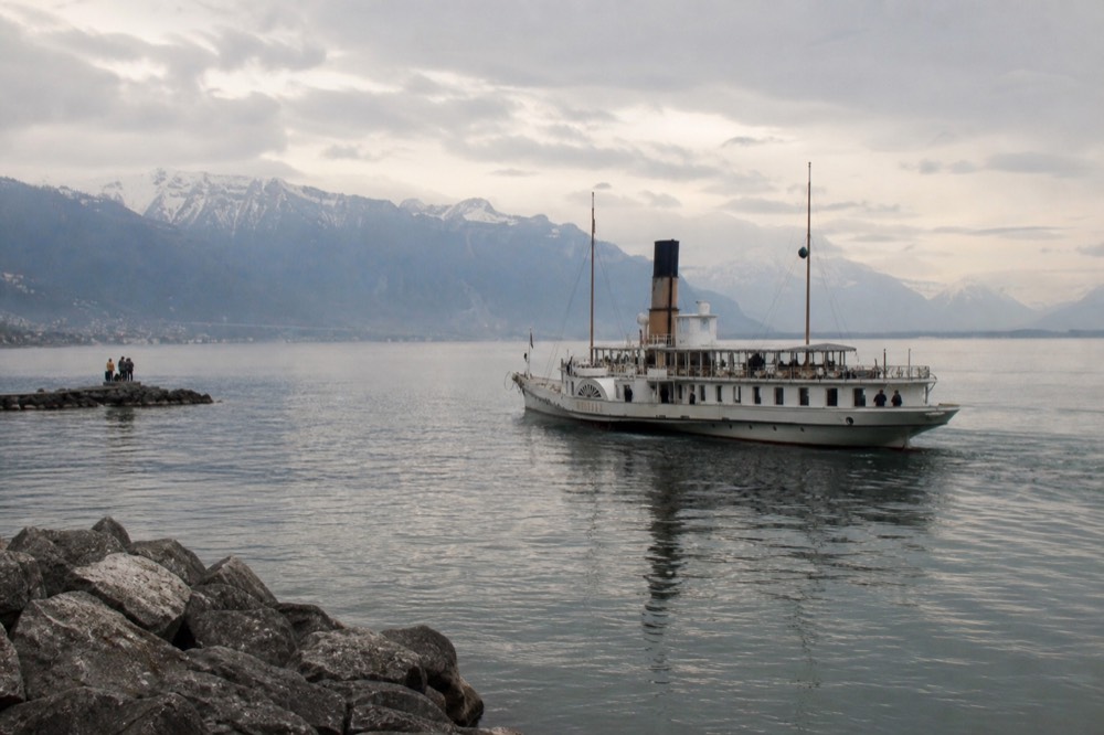 A Belle Époque paddle steamer on Lake Geneva off Montreux, the Riviera shoreline and Alps across the water