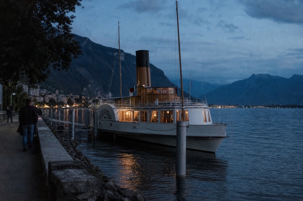 A Belle Époque paddle steamer moored at Montreux on Lac Léman, its side paddle box and tall funnel above the deck