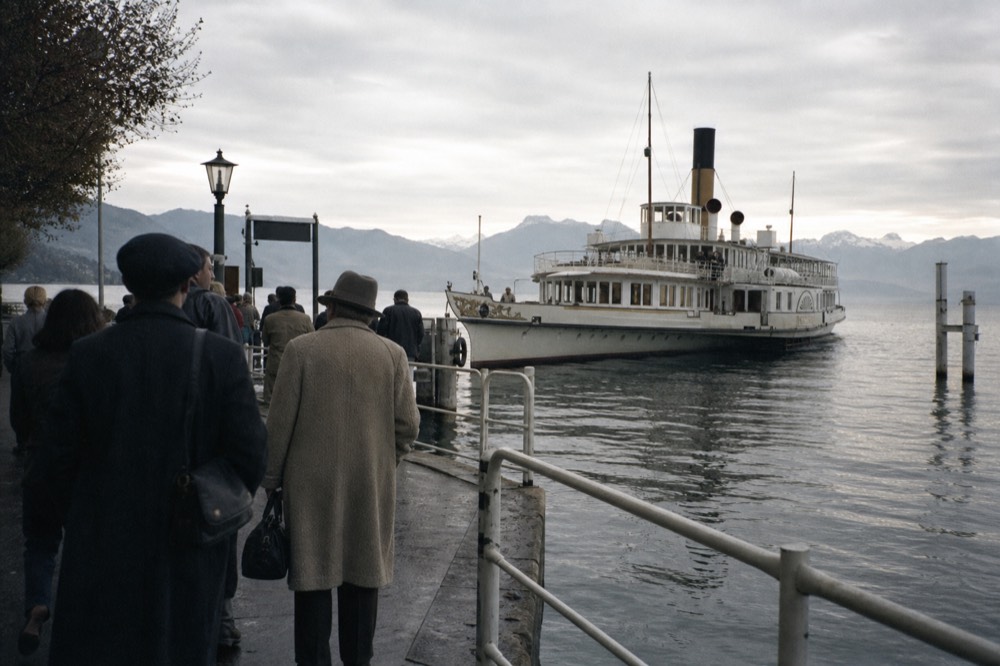 A Belle Époque paddle steamer arriving at a Lac Léman pier near Montreux, passengers waiting to board on the quay