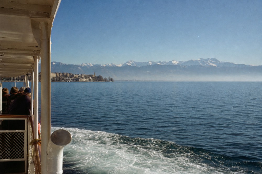 The Lausanne-Ouchy waterfront on Lake Geneva at the start of a scenic cruise, the Alps across the water