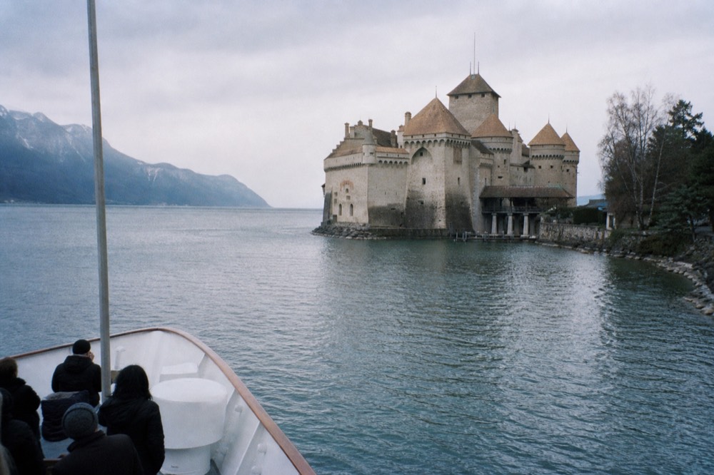 Château de Chillon rising off the shore of Lake Geneva near Veytaux, seen from an approaching cruise boat