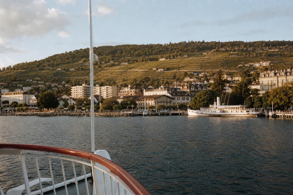 The lakefront of Évian-les-Bains on the French shore of Lake Geneva seen from an approaching boat