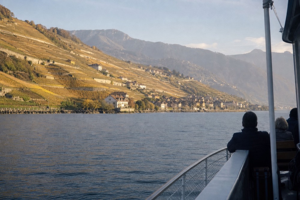 Wide view of the Lavaux vineyard terraces and Lac Léman from a boat, villages tucked among the vines