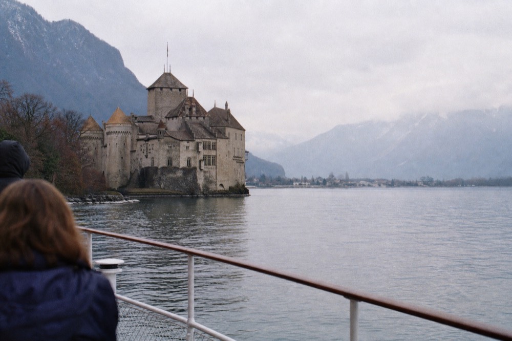 Château de Chillon on its rock over Lake Geneva near Veytaux, seen from an approaching cruise boat off Montreux