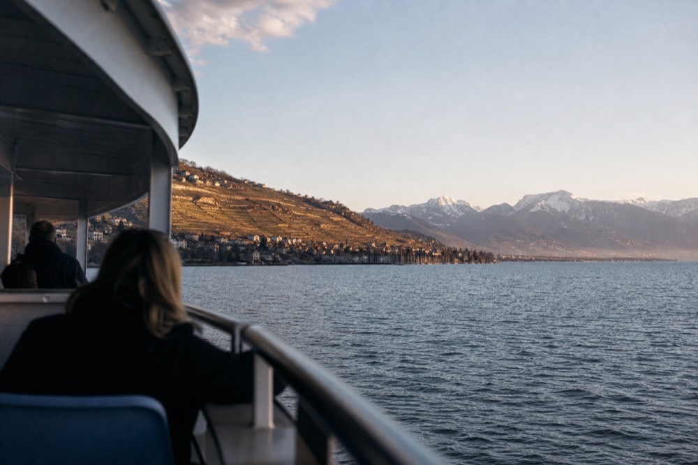 A scheduled CGN boat crossing Lake Geneva off Lausanne-Ouchy, the Alps standing across the water