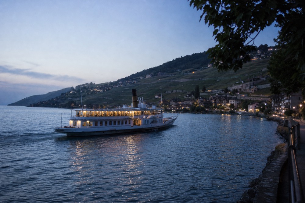 A CGN boat passing the Lavaux vineyard terraces on Lake Geneva between Lausanne and Vevey, the slopes stepping down to the water